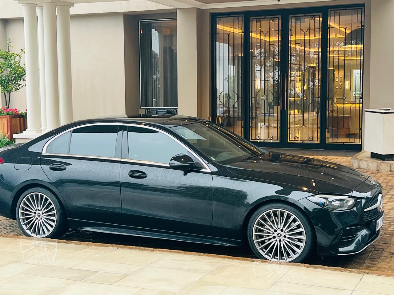 Mercedes C-Class side profile at hotel entrance