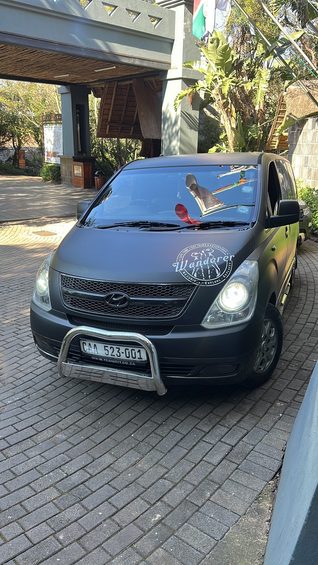 Wanderer branded Hyundai van at hotel entrance